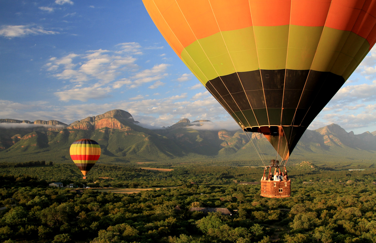 Two balloons with mountain background